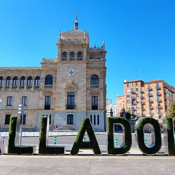 Edificio histórico con letras verdes que forman la palabra "Valladolid" en primer plano.